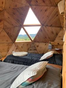 a room with two beds and a window at Nomade Patagonia Glamping & Domos in Trevelín