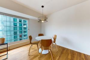 a dining room with a table and chairs and a window at Next to the Market at Newmark in Seattle