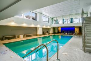 a large pool with blue water in a building at Next to the Market at Newmark in Seattle