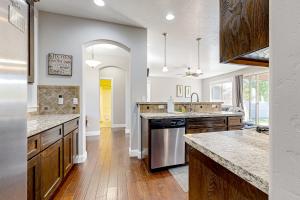 a large kitchen with wooden floors and white walls at Meet Me in Meridian in Meridian