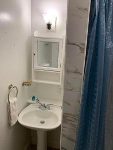 a bathroom with a sink and a mirror at Spacious 2nd floor split level with scenic views of Gloucester in Gloucester