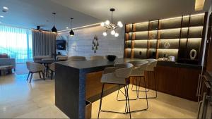 a kitchen with a bar with stools in a room at Solaz, a Luxury Collection Resort, Los Cabos in San Jos&eacute; del Cabo