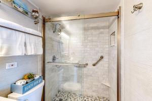 a bathroom with a shower with a glass door at Turtle Time Suite in Satellite Beach +25 photos
