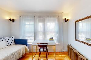 a bedroom with a desk and a bed and a window at The Bean House Upstairs and Downstairs Unit in Camden