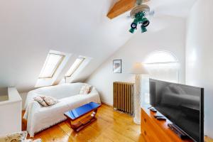 a bedroom with a bed and a flat screen tv at The Bean House Upstairs and Downstairs Unit in Camden