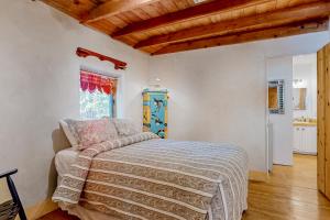 a bedroom with a bed in a room with wooden ceilings at Casa Serenity in El Padro