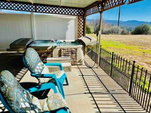 a porch with a hot tub and two chairs on a patio at Crane Suite Hot Tub Bbq King Bed- Sleeps 4 in Ahwahnee +19 photos