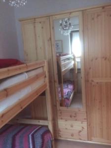 a bedroom with two bunk beds and a mirror at BIS Vipiteno in Vipiteno