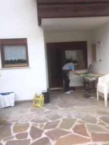 a man is painting a wall in a room at BIS Vipiteno in Vipiteno