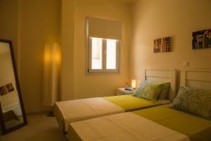 a bedroom with two beds and a window at Sea view houses in Kamari