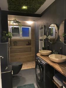 een badkamer met 2 wastafels en een wasmachine bij Maison Lyon-Bron Eurexpo - Stadium Groupama in Bron