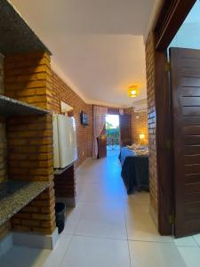 a hallway of a hotel with a room with a table at Pousada Casa Do Alemão in Flecheiras
