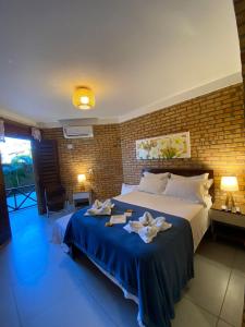 a bedroom with a large bed with towels on it at Pousada Casa Do Alemão in Flecheiras +121 photos