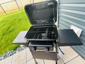 a grill sitting on a table with a tv on it at Beautiful 1 bedroom apartment - private entrance in Moncton