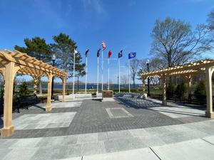 a park with benches and umbrellas and flags at Glorious Suite near Downtown with washer/dryer in Gloucester