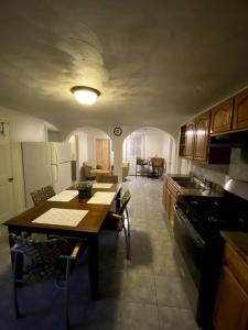 a kitchen with a table and a dining room at Glorious Suite near Downtown with washer/dryer in Gloucester
