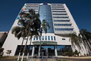 a tall building with palm trees in front of it at COBERTURA DUPLEX 70 m COM HIDRO NO MELHOR HOTEL DE TAGUATINGA in Taguatinga