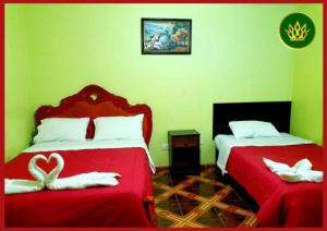a bedroom with two beds with a heart on them at HOTEL REY DE ORO in Chiclayo