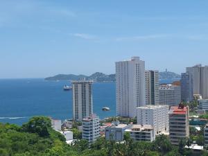 una città con edifici alti e un bacino d'acqua di CLUB DE GOLF ad Acapulco