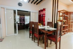 a dining room with a wooden table and chairs at Bahay Ni Kikay Vacation Rental - WiFi Included in General Santos