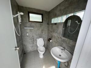 a bathroom with a toilet and a sink at See Scape Camping Khaokho in Ban Nong Bong