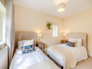 a bedroom with two beds and a window at Strawberry Field - Uk45169 in Southwell