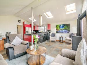 a living room with couches and a table at Crynant Countryside Retreat in Crynant