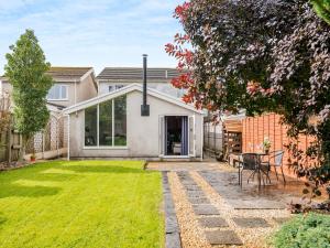 a garden with a patio and a house at Crynant Countryside Retreat in Crynant