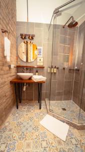 a bathroom with a sink and a shower at Socialtel Candelaria Bogotá in Bogotá