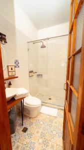 a bathroom with a shower and a toilet and a sink at Socialtel Candelaria Bogotá in Bogotá