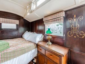 a bedroom with a bed and a table with a lamp at Peaceful Travelers Rest - Uk44790 in Grainthorpe