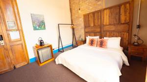 a bedroom with a white bed and a mirror at Socialtel Candelaria Bogotá in Bogotá