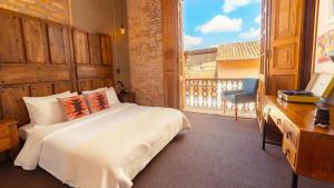 a bedroom with a bed and a large window at Socialtel Candelaria Bogotá in Bogotá