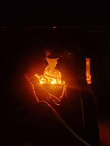 two people are kissing in front of a fire at The Edgware Cabana in Nuwara Eliya