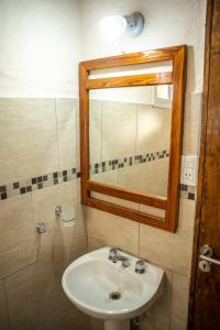 a bathroom with a sink and a mirror at El Campo in Sierra de la Ventana