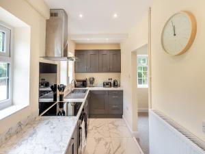 a kitchen with a large clock on the wall at Apple Orchard - Uk45170 in Southwell