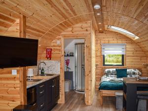 a kitchen and living room in a log cabin at Cheviot - Ukc6789 in Fort William