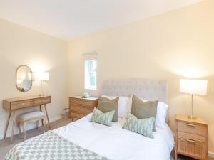 a bedroom with a bed and a desk and a mirror at Apple Orchard - Uk45170 in Southwell
