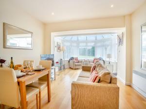 a living room with a table and a couch at Trem Yr Afon in Ciliau-Aeron