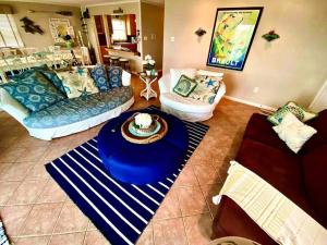 a living room with a blue table in the middle at BEACH FRONT Luxury Home + Direct Beach Access in Ocean City