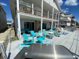 een huis met blauwe stoelen en een terras bij BEACH FRONT Luxury Home + Direct Beach Access in Ocean City