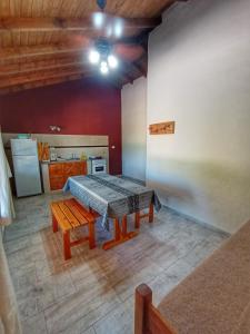 a kitchen with a table in the middle of a room at El Campo in Sierra de la Ventana