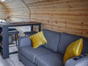 a gray couch with yellow pillows in a room at Black Grouse - Ukc6790 in Fort William
