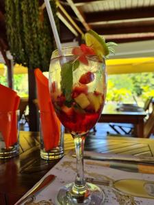 a drink with a straw in a glass on a table at La kaz nature bien-être in Petit-Bourg