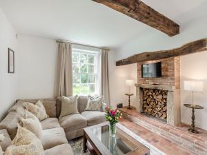 a living room with a couch and a fireplace at The Farmhouse - Uk45171 in Southwell