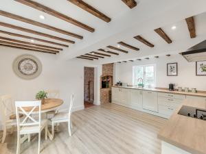 a kitchen and dining room with a table and chairs at The Farmhouse - Uk45171 in Southwell