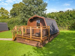 a large wooden house sitting in the grass at Milo - Uk45070 in Llandybie