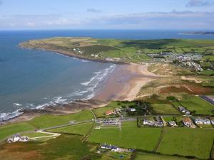 an aerial view of a beach and the ocean at The Burrow in Braunton