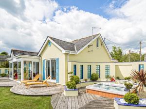 a house with a pool and a patio at Pentire in Holbeton