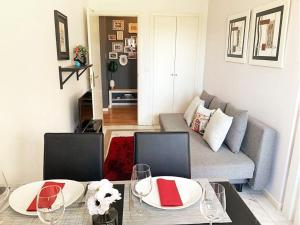 a living room with two tables and a couch at Lisbon Relax Pool Apartment - Free Parking Garage in Lisbon